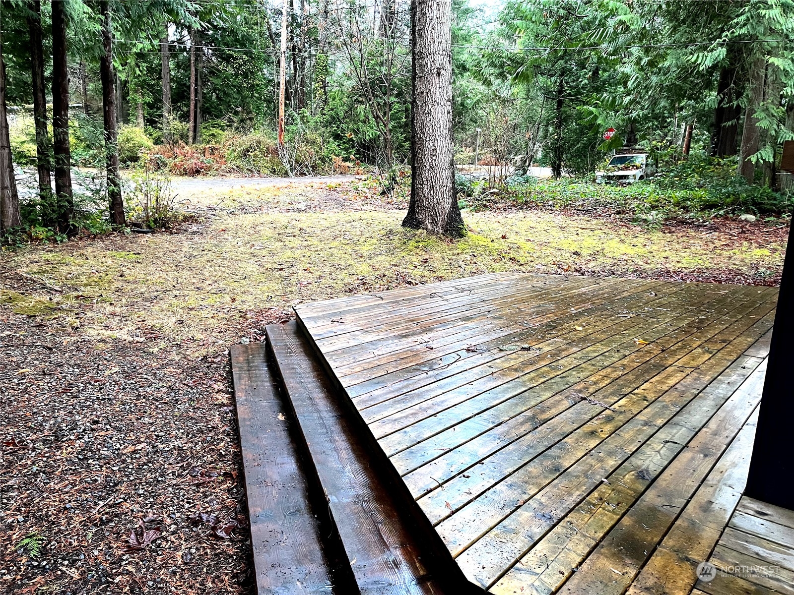 68 Regina Way Point Roberts, WA 98281 - Photo 2 of 24 a view of a yard with wooden fence