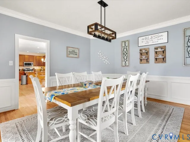 a view of a dining room with furniture and wooden floor
