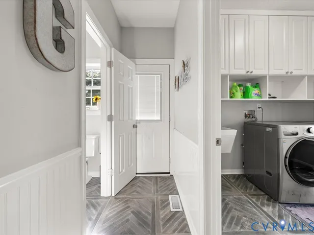 a view of a hallway with washer and dryer