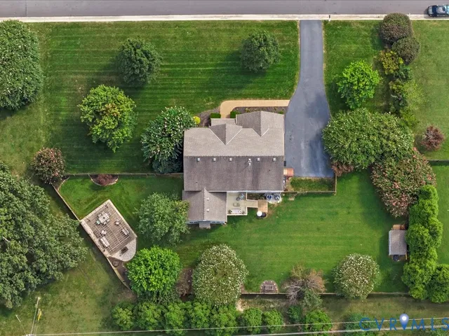an aerial view of a house with garden space and outdoor seating