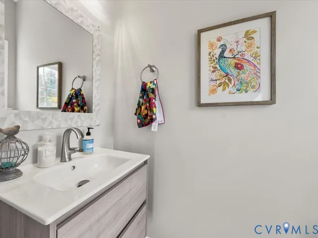 a bathroom with a sink a vanity and a mirror