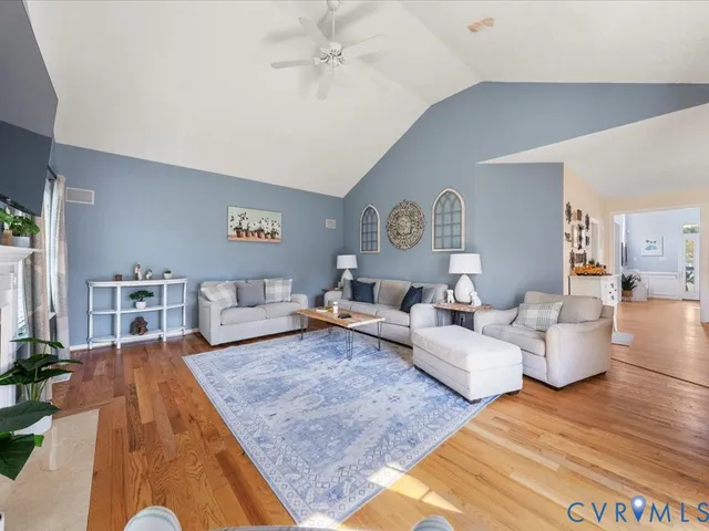 a living room with furniture and wooden floor