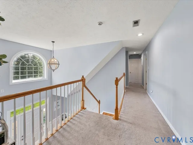 a spacious bedroom with a bed and a flat screen tv