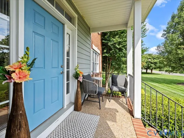 a view of balcony with two chairs and a potted plant