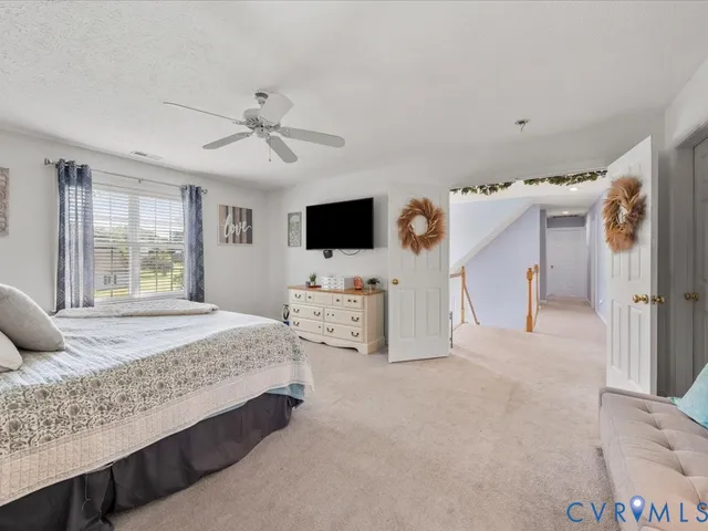 a bedroom with a bed a rug and a window