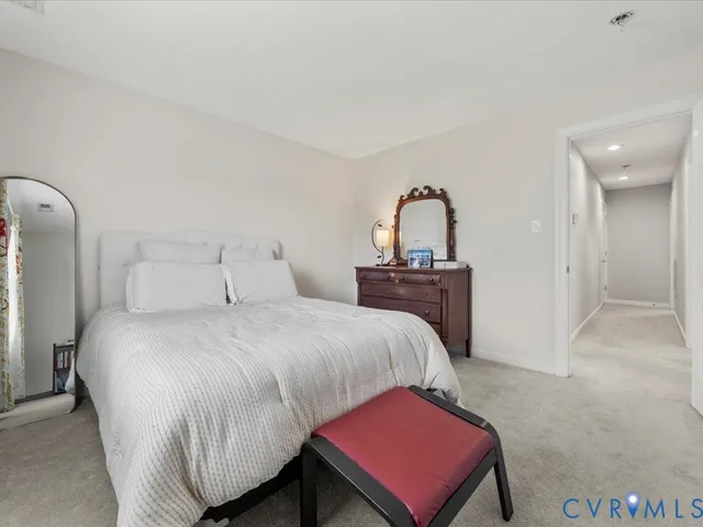 a bedroom with a bed and a large mirror