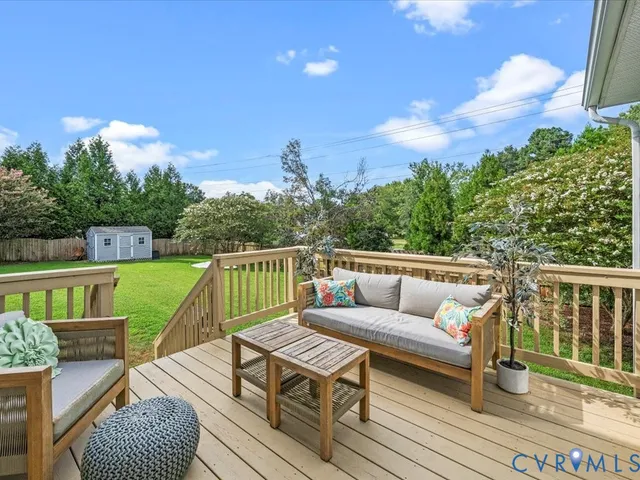 a view of a patio with a table chairs and a backyard