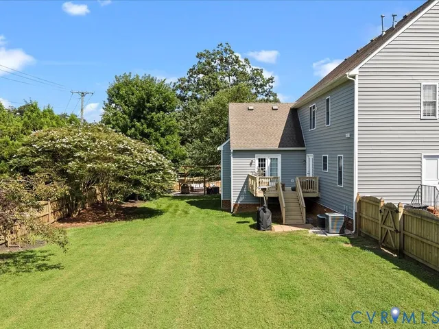 an aerial view of a house with a yard and lake view