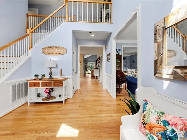 a view of living room kitchen with furniture and a chandelier