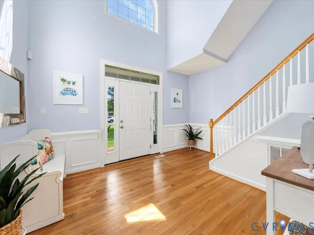 a view of a livingroom with wooden floor and stairs