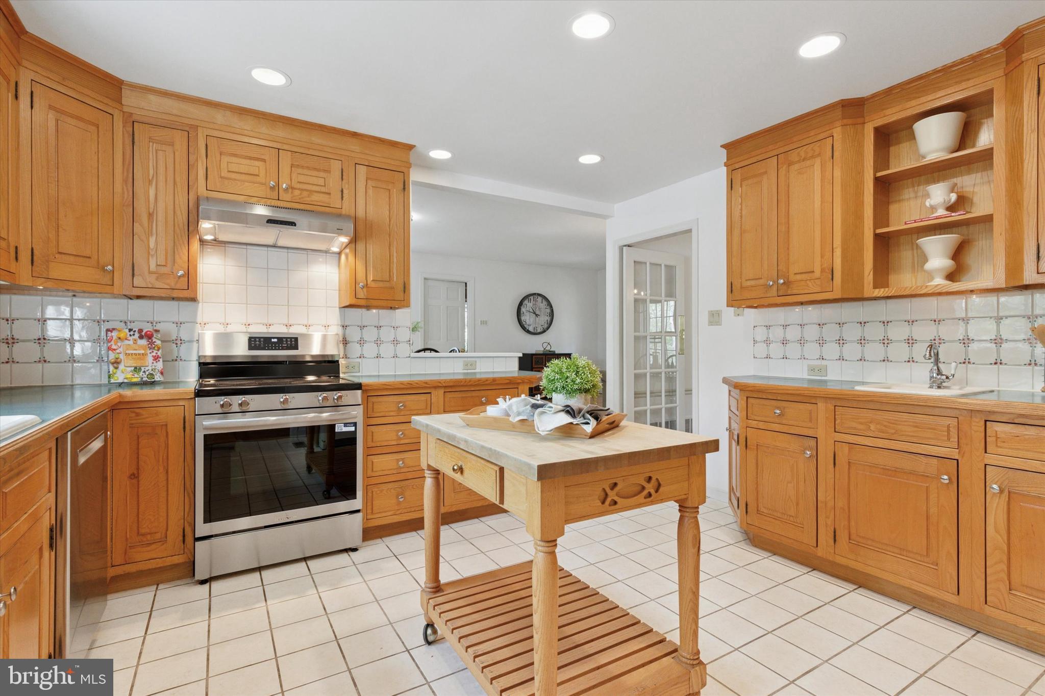 99 Elfman Drive Doylestown, PA 18901 - Photo 16 of 35 a kitchen with stainless steel appliances granite countertop a stove a sink and a microwave