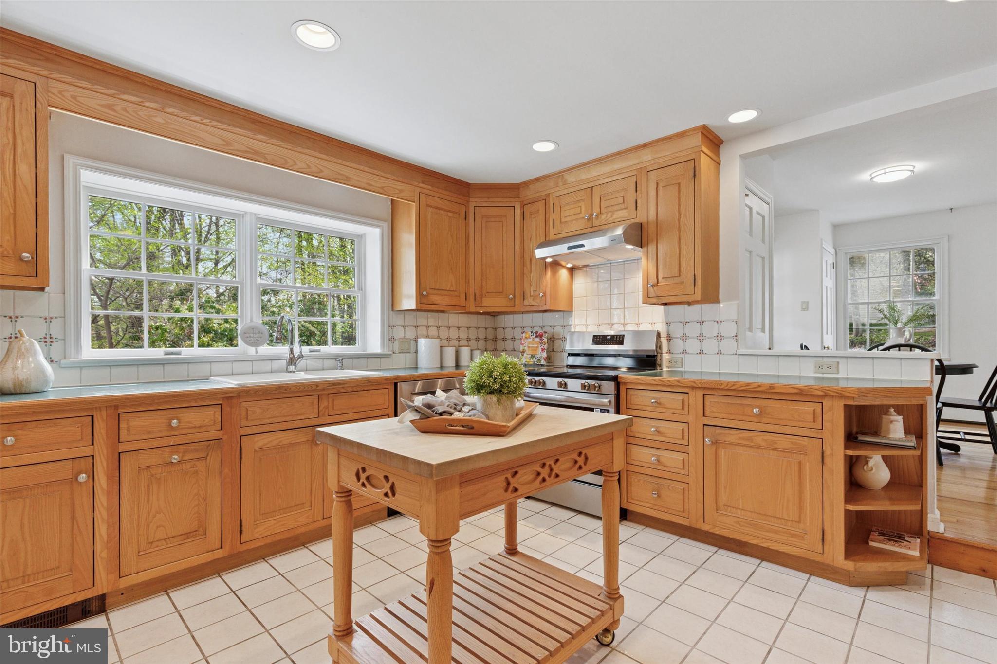 99 Elfman Drive Doylestown, PA 18901 - Photo 17 of 35 a kitchen with stainless steel appliances granite countertop a stove a sink and a microwave