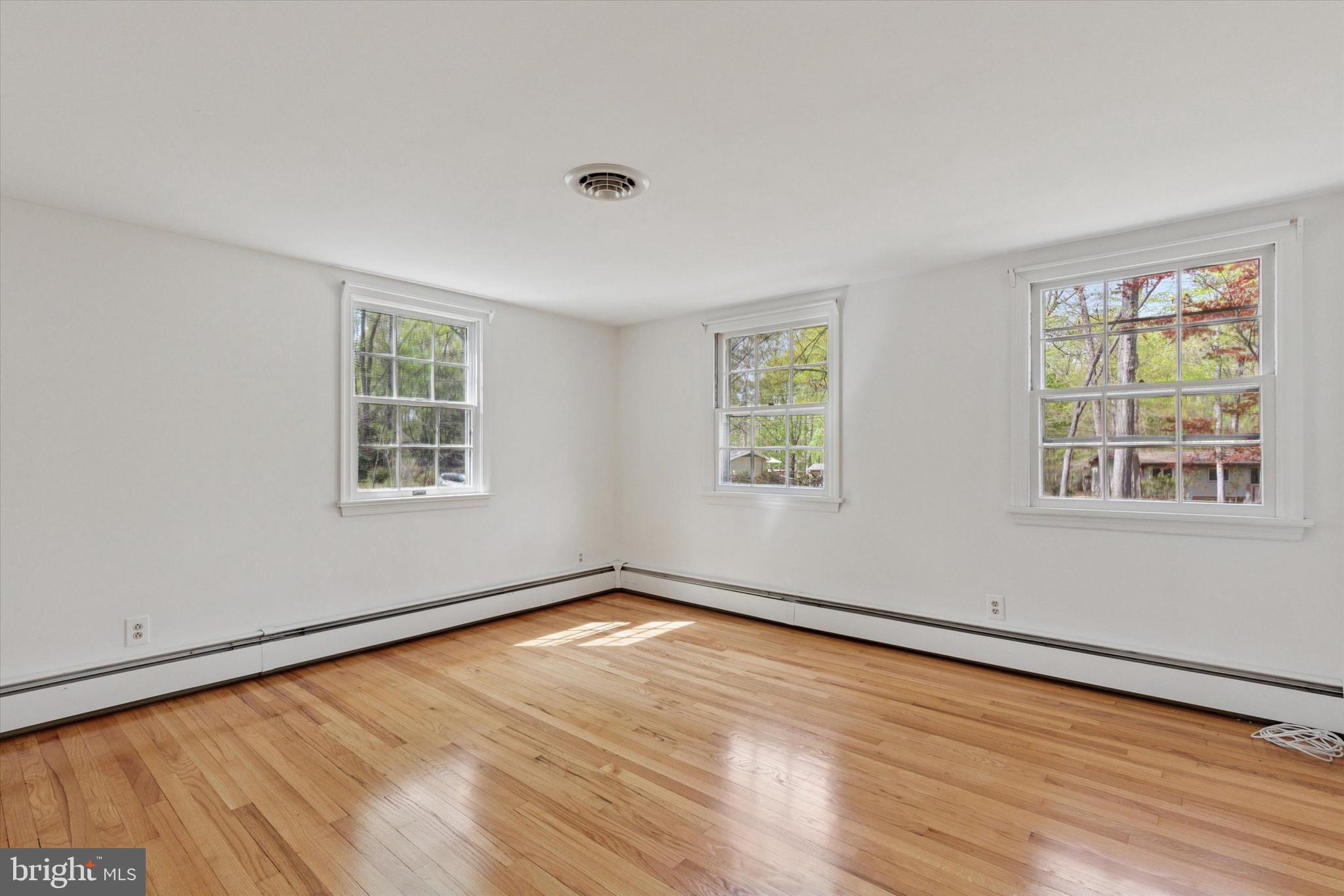 99 Elfman Drive Doylestown, PA 18901 - Photo 18 of 35 a view of an empty room with wooden floor and a window