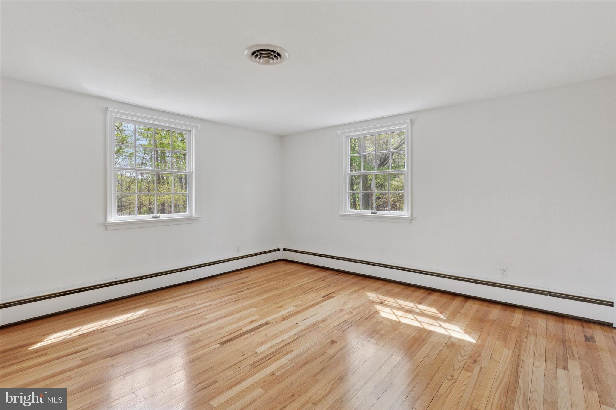 99 Elfman Drive Doylestown, PA 18901 - Photo 19 of 35 a view of an empty room with wooden floor and a window