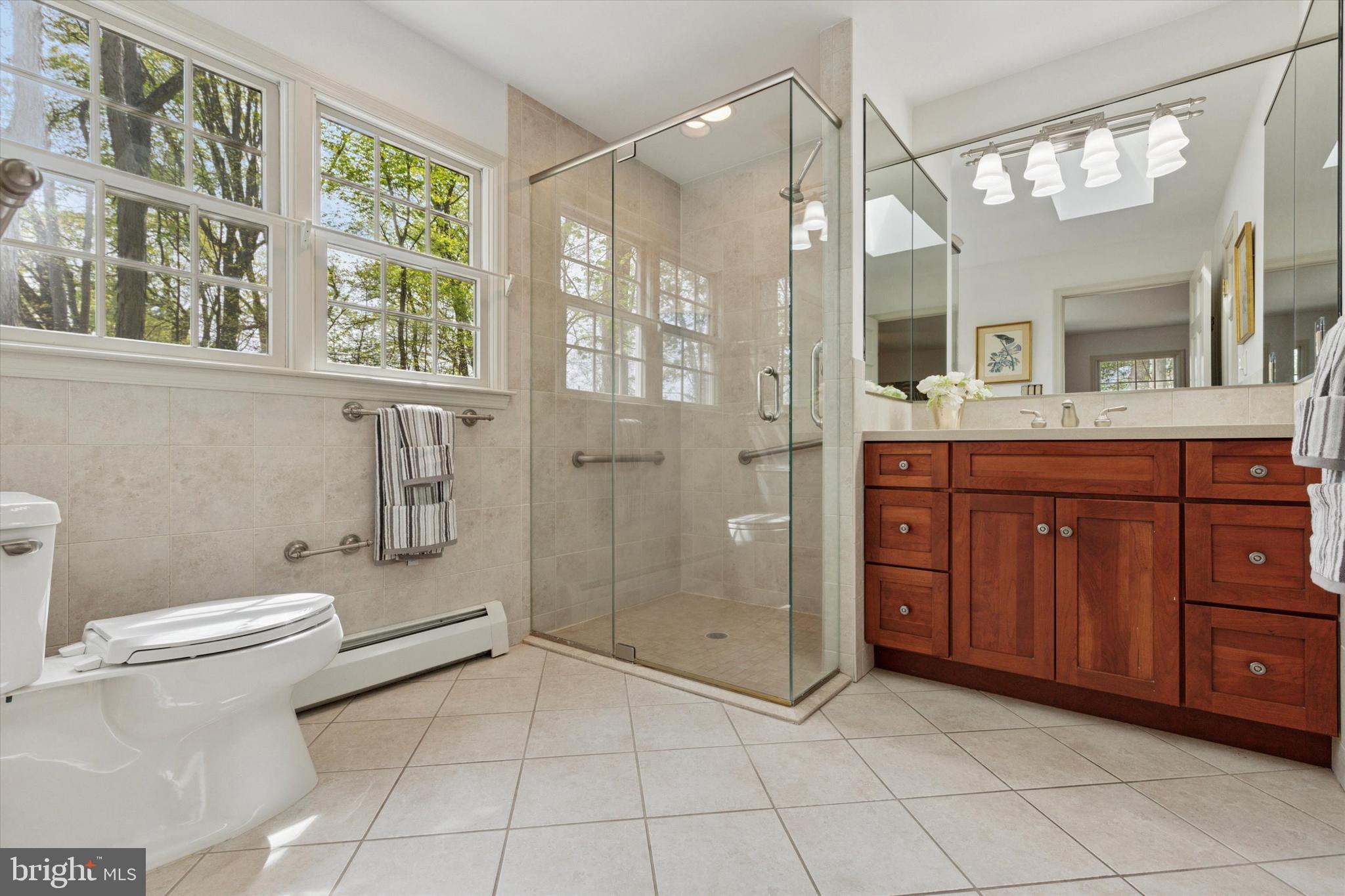 99 Elfman Drive Doylestown, PA 18901 - Photo 23 of 35 a bathroom with a granite countertop sink a toilet and a mirror