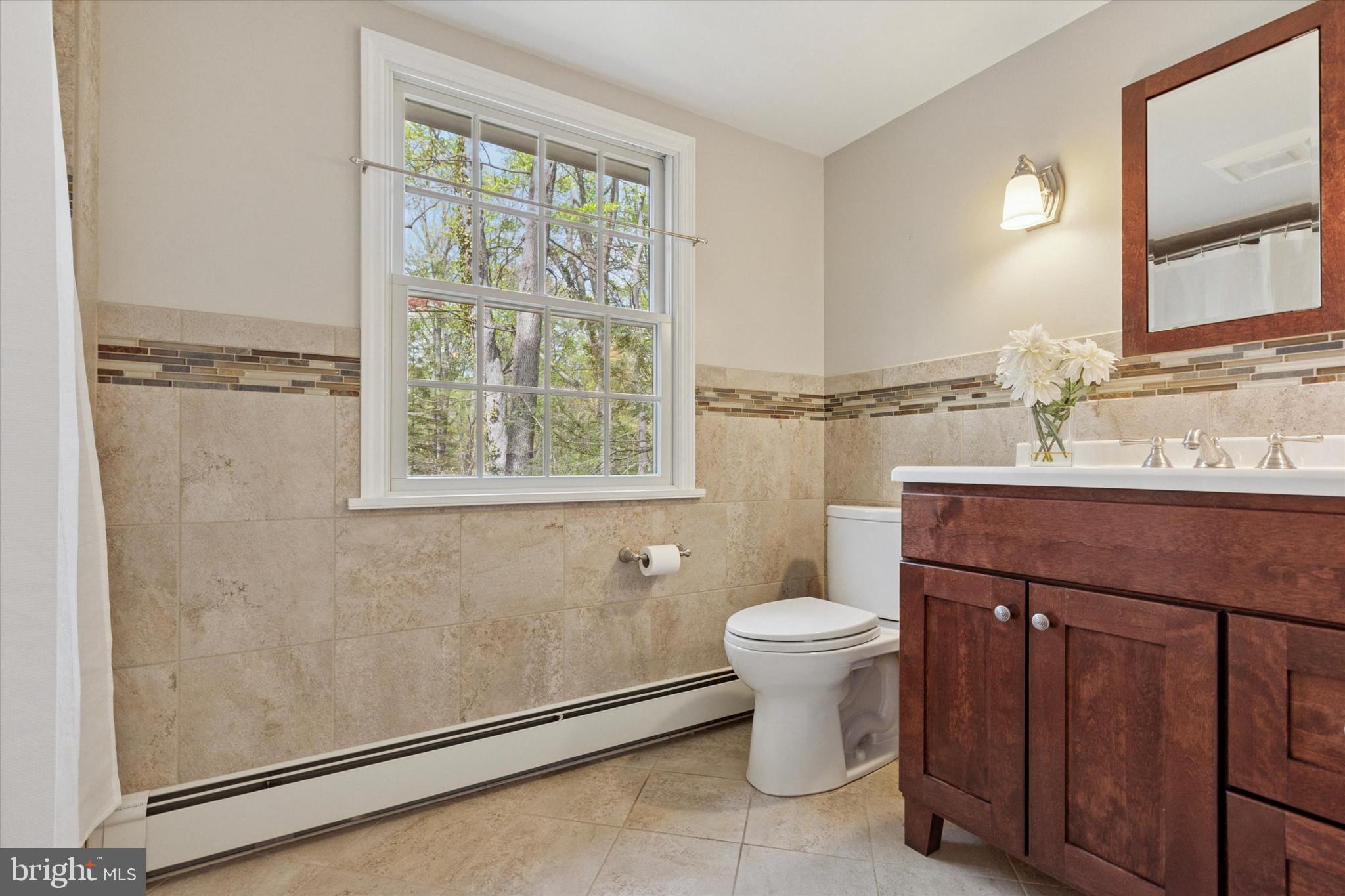 99 Elfman Drive Doylestown, PA 18901 - Photo 27 of 35 a bathroom with a toilet sink and a mirror