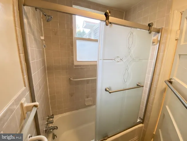 a bathroom with a shower and a glass door