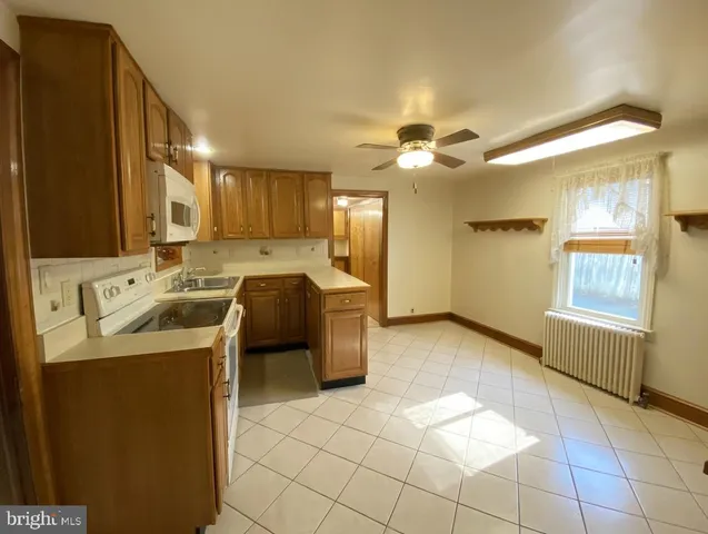 a kitchen with a sink a stove cabinets and refrigerator