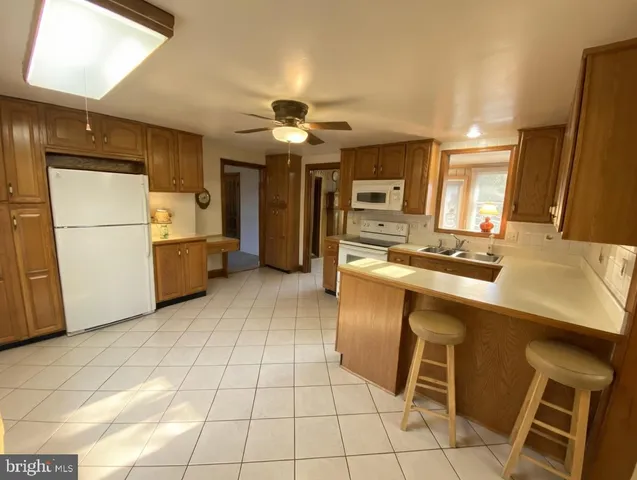 a kitchen with cabinets and refrigerator