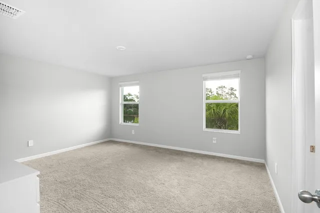 an empty room with windows and closet