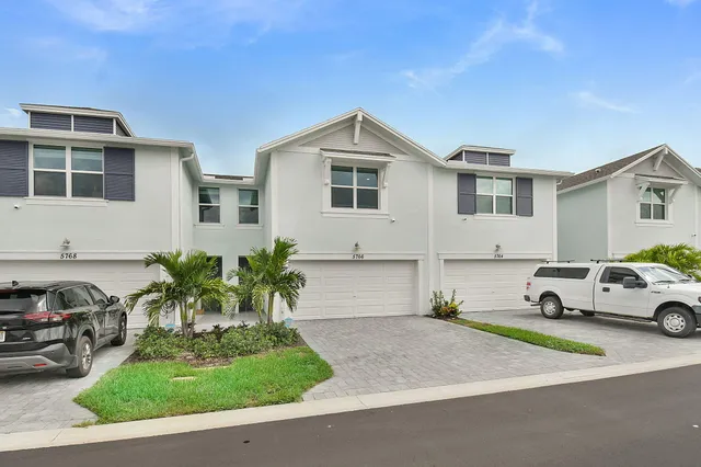 a aerial view of a house with table and chairs potted plants