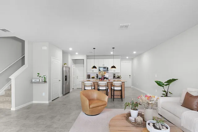 a living room with furniture and a potted plant