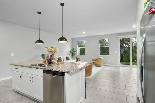 a view of a kitchen with sink and microwave
