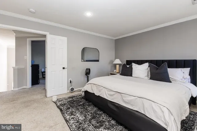 a bedroom with bed and a night stand