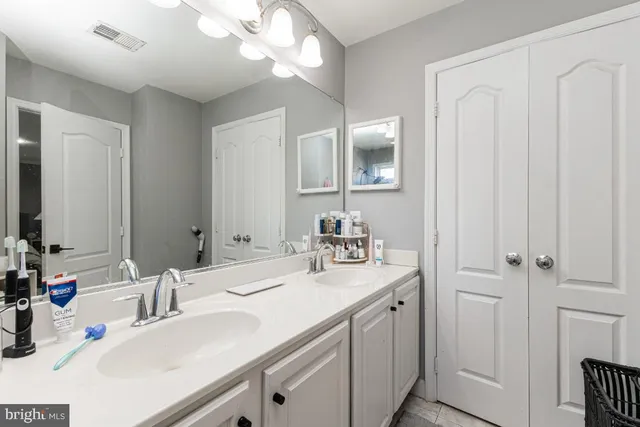 a bathroom with a sink vanity and a mirror