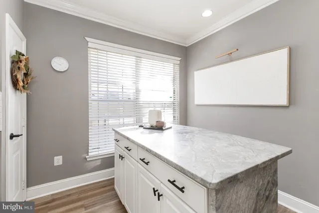 a kitchen with a stove a sink and a window