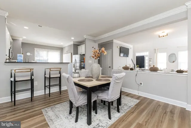 a view of a dining room with furniture and wooden floor