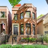 front view of a brick house with a small yard