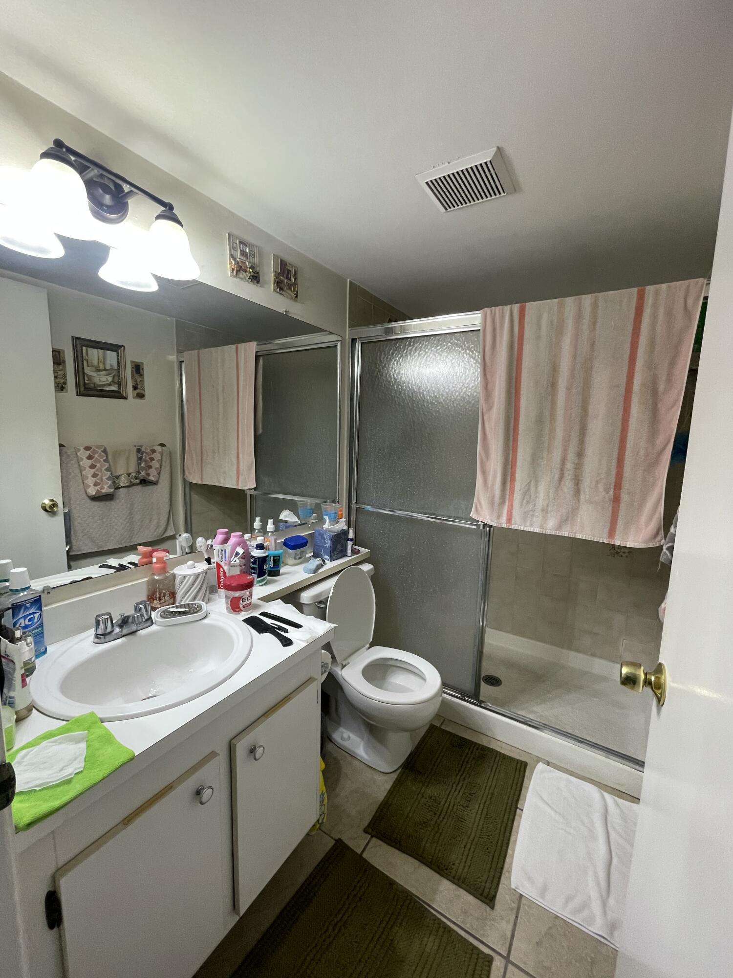 812 Sky Pine Way, Unit D1 Greenacres, FL 33415 - Photo 11 of 17 a bathroom with a sink mirror vanity and toilet