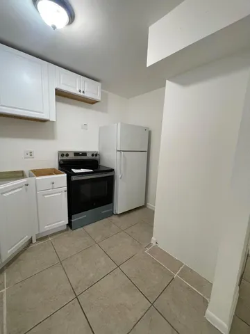 a kitchen with a sink a stove and refrigerator