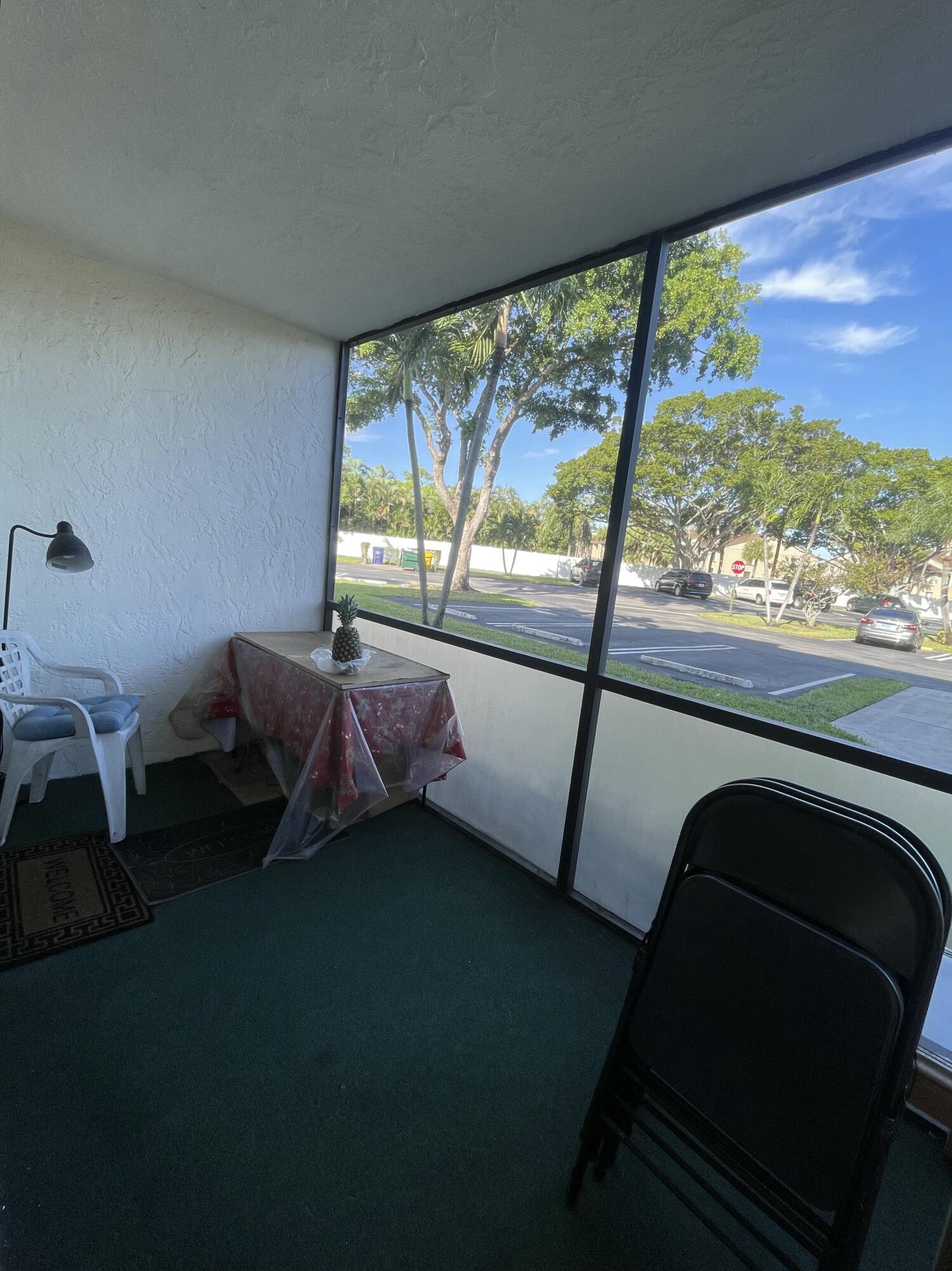 812 Sky Pine Way, Unit D1 Greenacres, FL 33415 - Photo 13 of 17 a living room with furniture and a floor to ceiling window