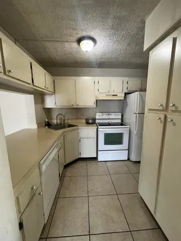 a kitchen with a cabinets stainless steel appliances and a counter space