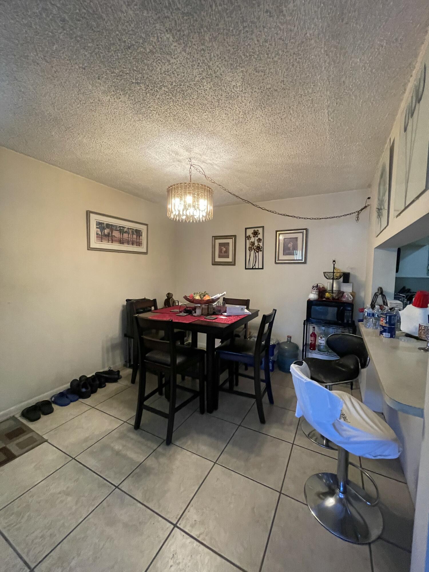 812 Sky Pine Way, Unit D1 Greenacres, FL 33415 - Photo 4 of 17 a room with furniture a rug and a window