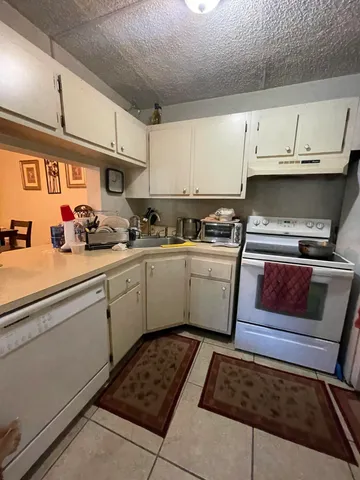 a kitchen with a sink stove and cabinets