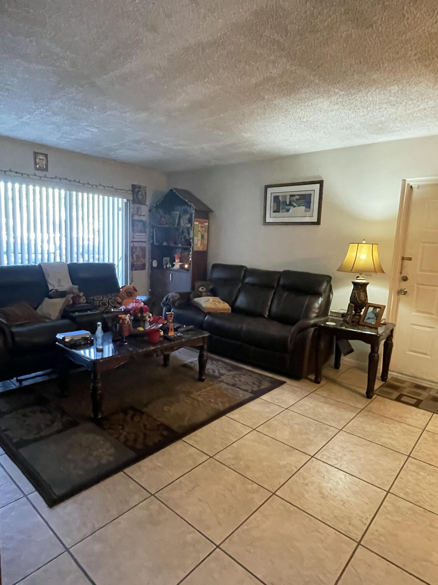 812 Sky Pine Way, Unit D1 Greenacres, FL 33415 - Photo 8 of 17 a living room with furniture and a window