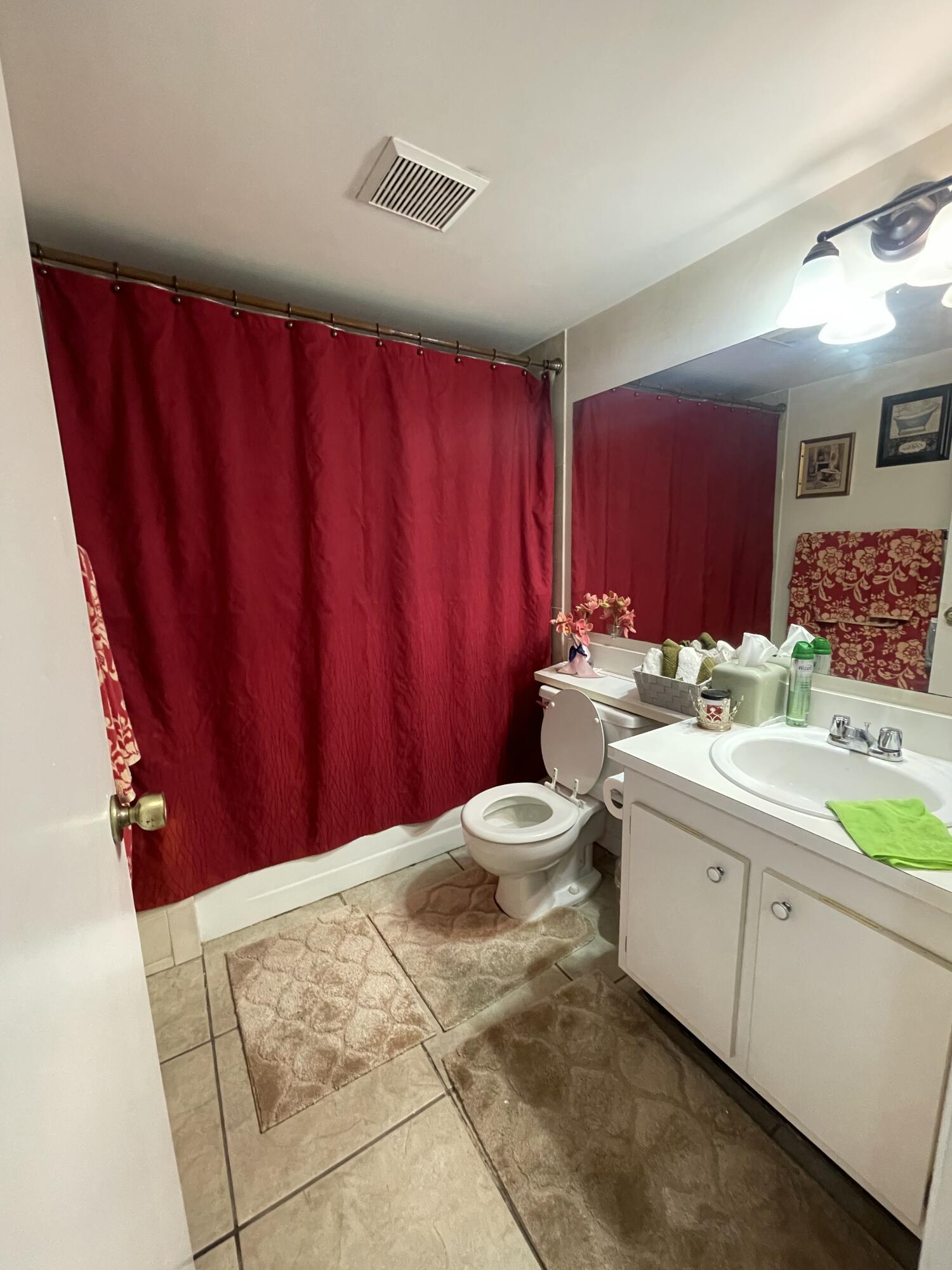 812 Sky Pine Way, Unit D1 Greenacres, FL 33415 - Photo 9 of 17 a bathroom with a sink mirror vanity and toilet