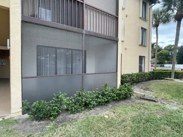 a house with potted plants in front of door