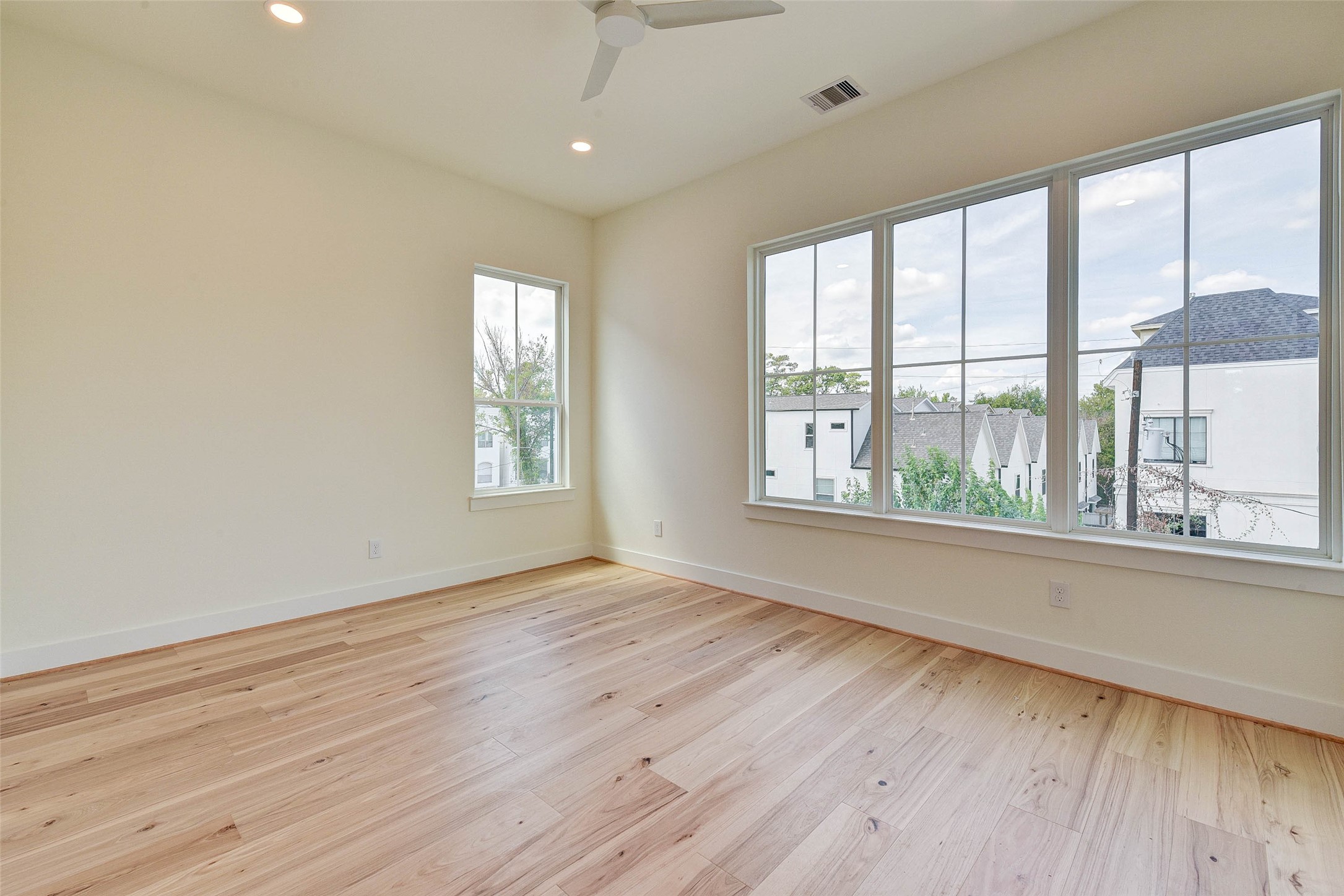 2516 Ohsfeldt Street Houston, TX 77008 - Photo 15 of 24 a view of an empty room with wooden floor and a window