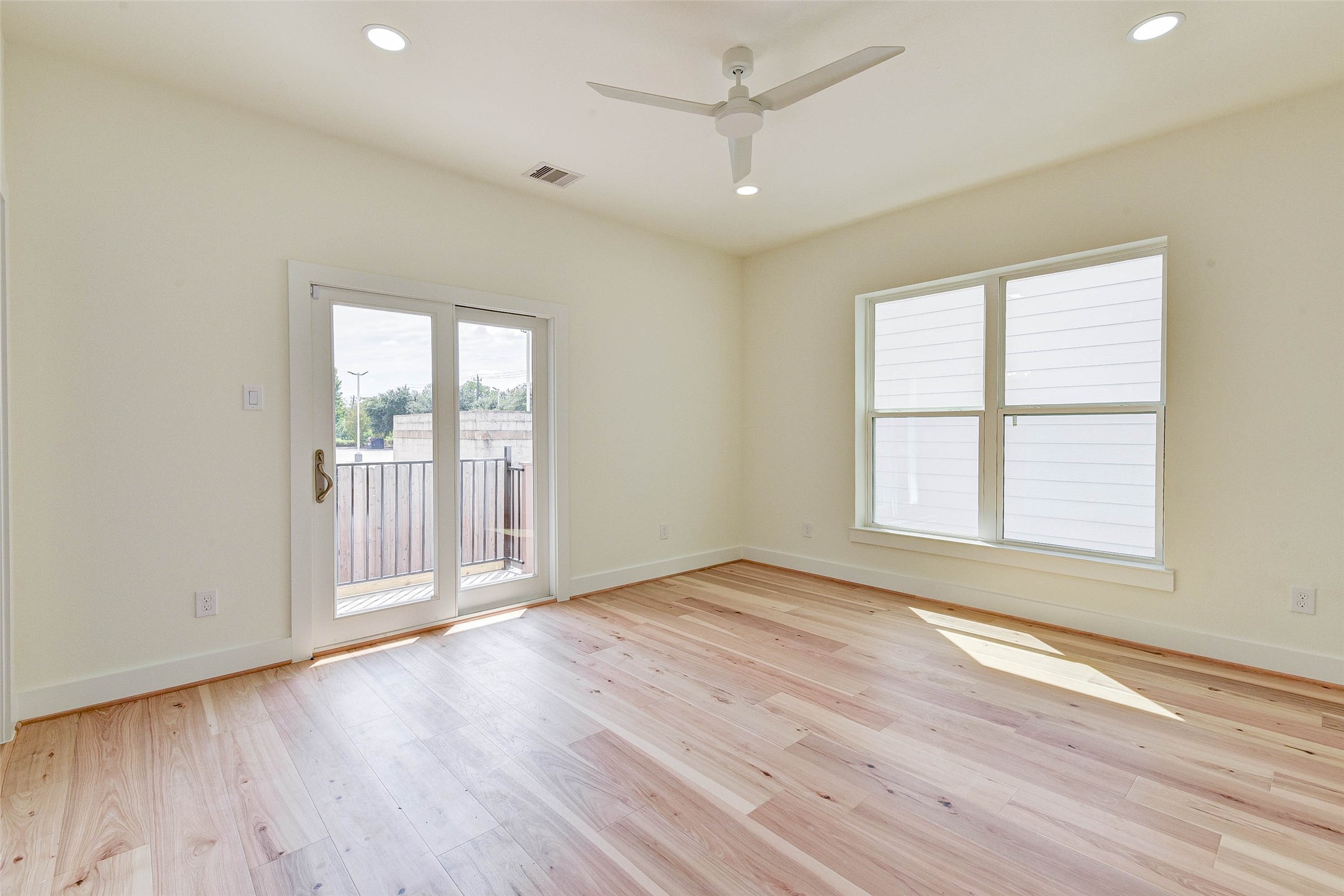 2516 Ohsfeldt Street Houston, TX 77008 - Photo 16 of 24 an empty room with wooden floor and windows