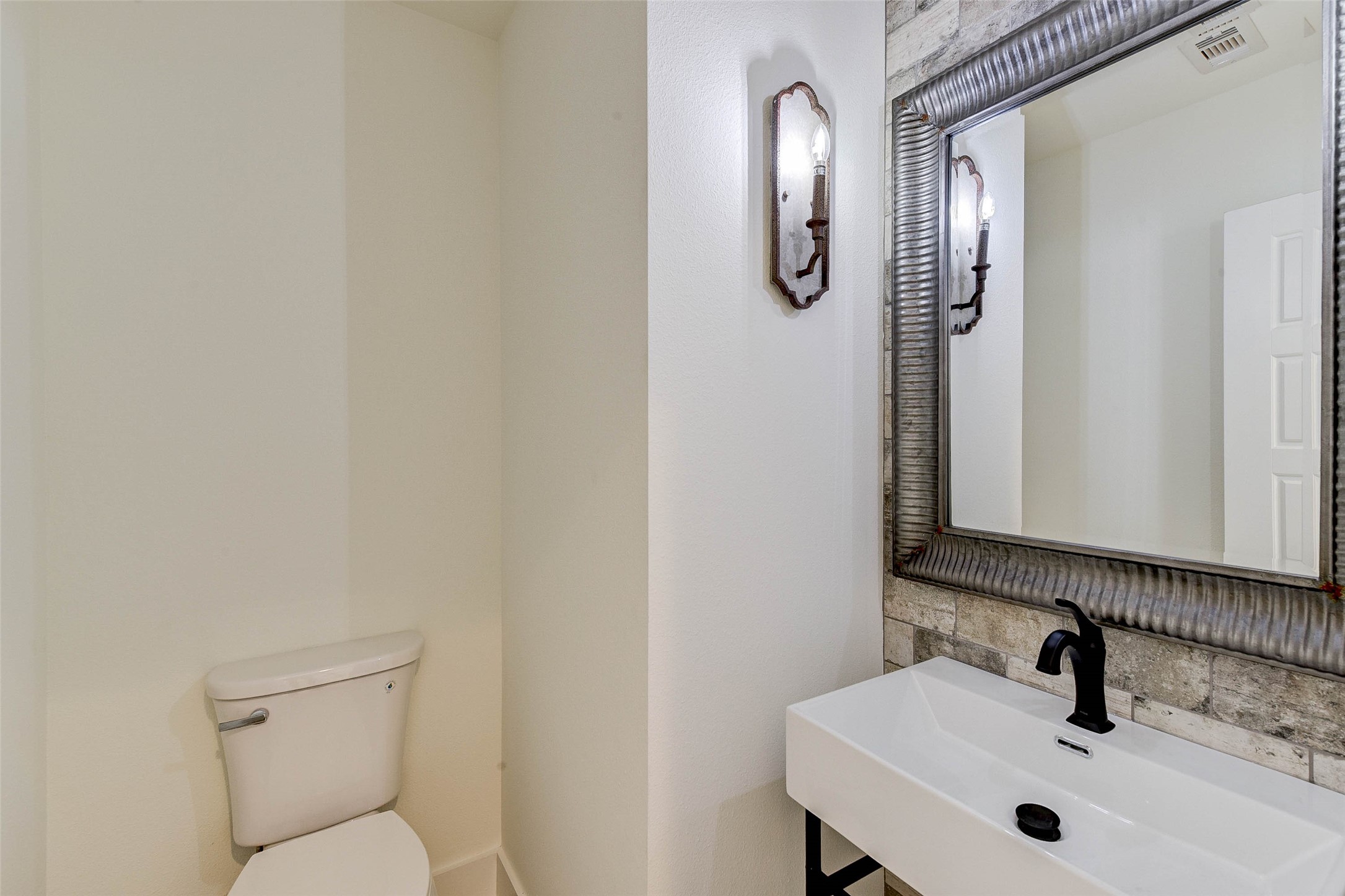 2516 Ohsfeldt Street Houston, TX 77008 - Photo 19 of 24 a bathroom with a sink and mirror with toilet