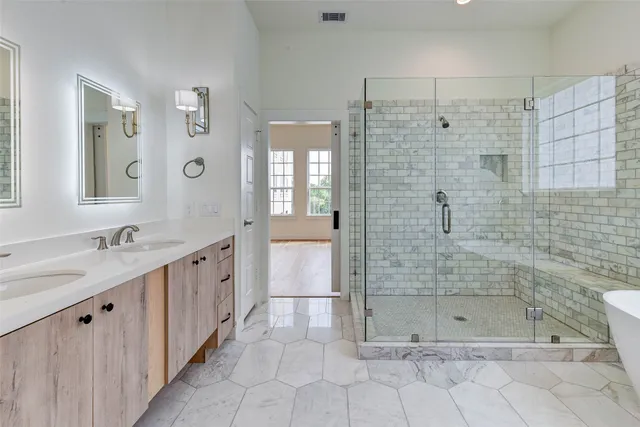 a bathroom with a bathtub and shower