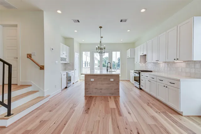 a kitchen with granite countertop a sink cabinets and wooden floor