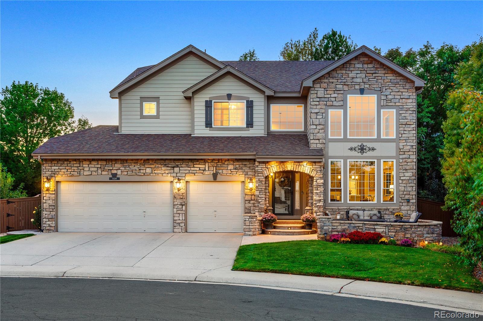 10289 South Dan Court Highlands Ranch, CO 80130 - Photo 1 of 36 a front view of a house with garden