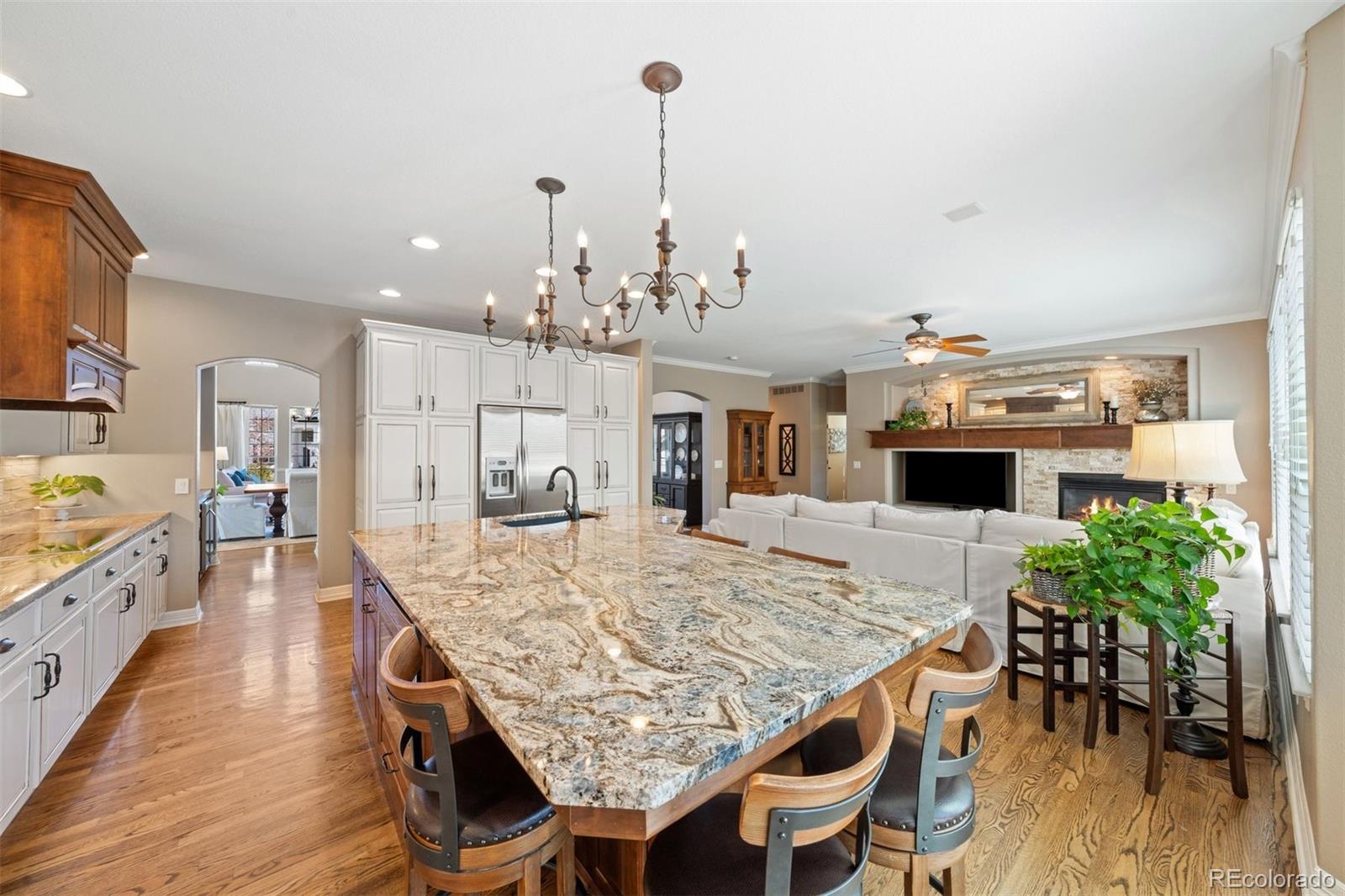 10289 South Dan Court Highlands Ranch, CO 80130 - Photo 11 of 36 a view of a dining room and livingroom with furniture wooden floor a chandelier