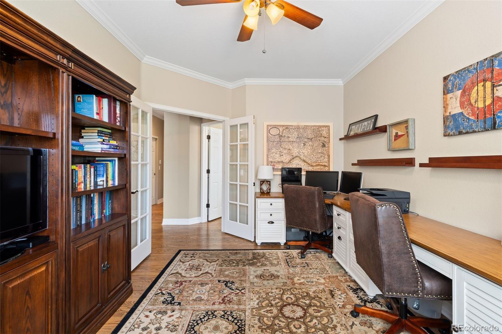 10289 South Dan Court Highlands Ranch, CO 80130 - Photo 14 of 36 a view of a workspace with furniture and staircase