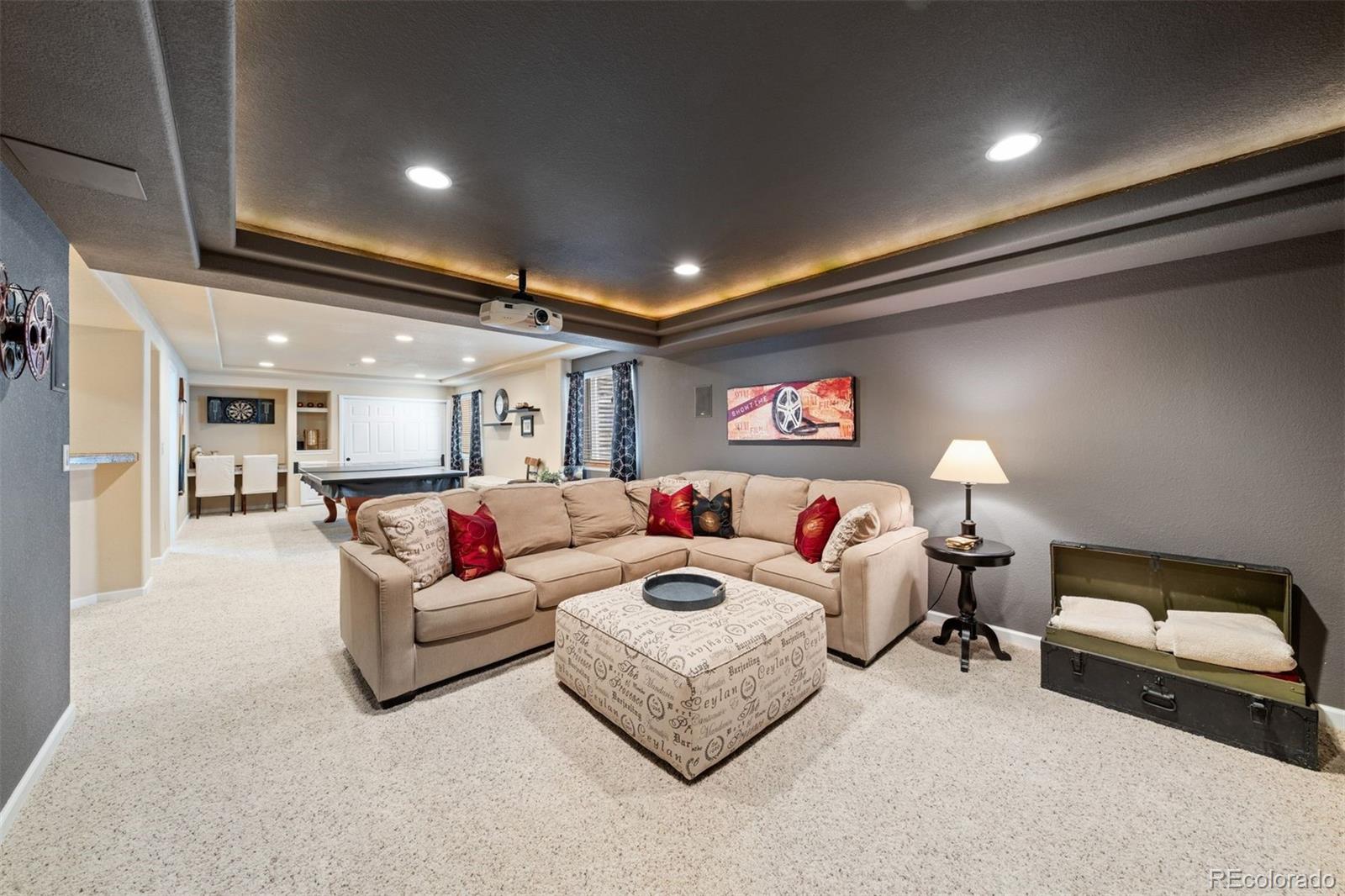 10289 South Dan Court Highlands Ranch, CO 80130 - Photo 27 of 36 a living room with furniture and a lamp